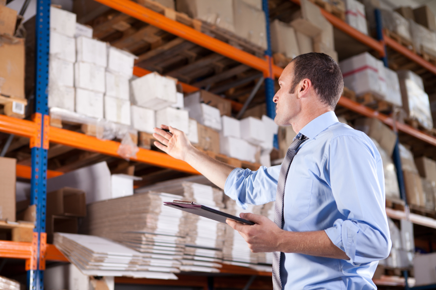 Man checking and looking through stocks in storage