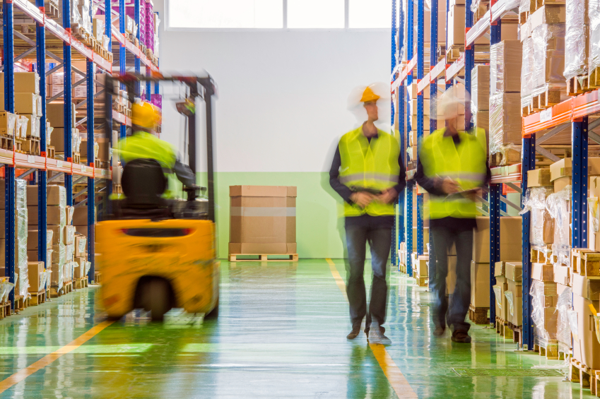 Men working and shifting and taking stock count in warehouse