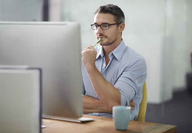 A cropped shot of a handsome businessman working at his desk