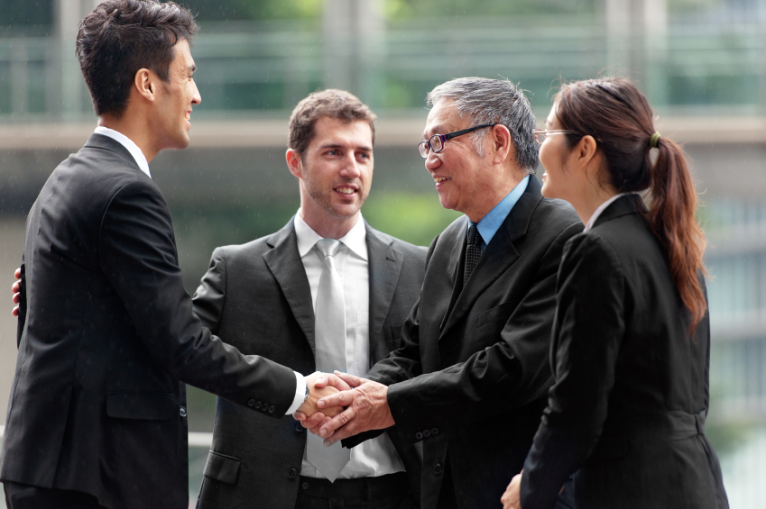 Men and woman in business suit shaking hands business agreement