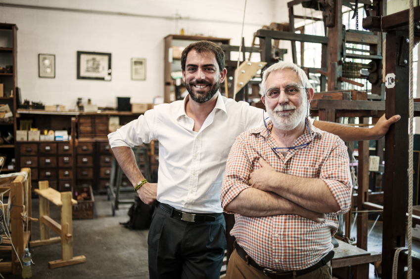 Father and son in their artisanal handicraft traditional textile factory