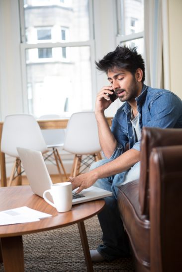 Man using laptop to answer the question can I open an Australian bank account online from overseas?