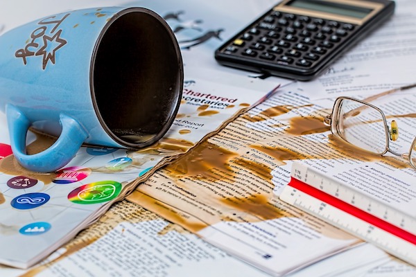 j tile trap coffee spilled all over paper and work